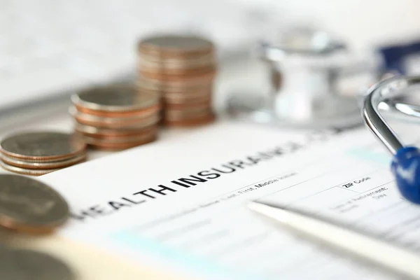 Stethoscope head metal quarter coins and silver pen lying on application form — Stock Photo, Image