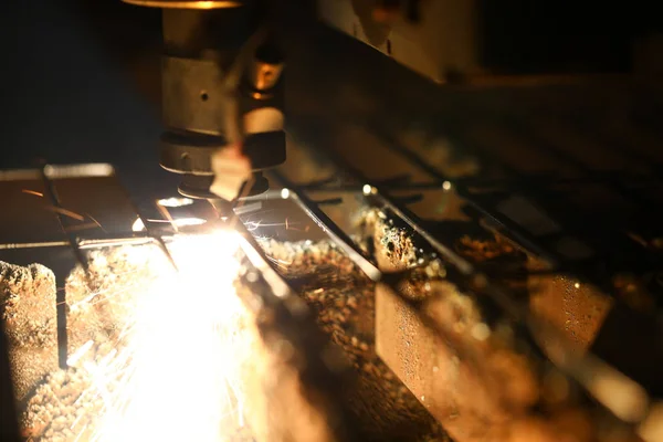 Bright blaze and sparkles while automated laser device cutting steel — Stock Photo, Image