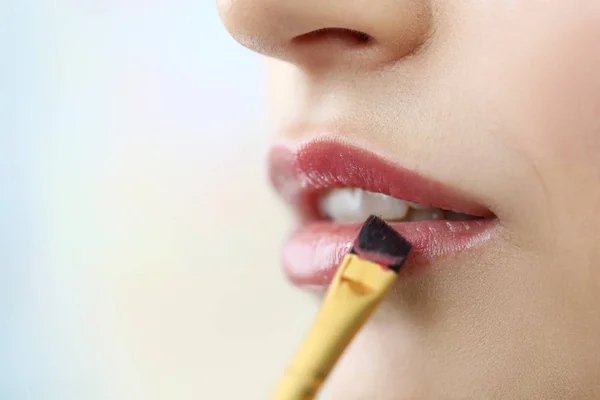 Opened mouth with brush painting lips in red color — Stock Photo, Image