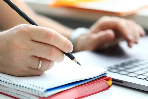 Male hand writing something with regular lead pencil Stock Photo