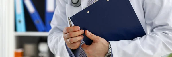 Male doctor hand hold document pad — Stock Photo, Image