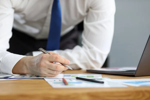 Man in business clothes leaned over table home