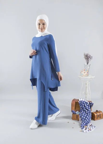 islamic hijab fashion. blonde woman wearing blue sport dress