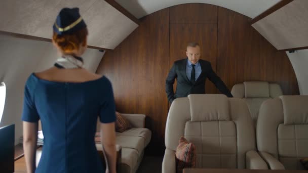 Stewardess helping passengers inside of air jet — Stock Video