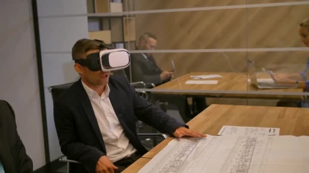 Бизнесмен и его коллеги работают с современным футуристическим виртуальным макетом — стоковое видео