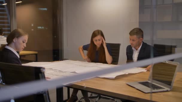 Businesspeople working with drawing at office — Stock Video