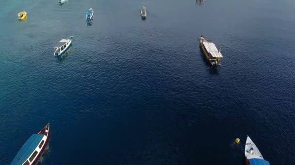 Tropical island aerial drone. Lombok, gili. Beautiful overview of the boats on water near coastal line — Stock Video
