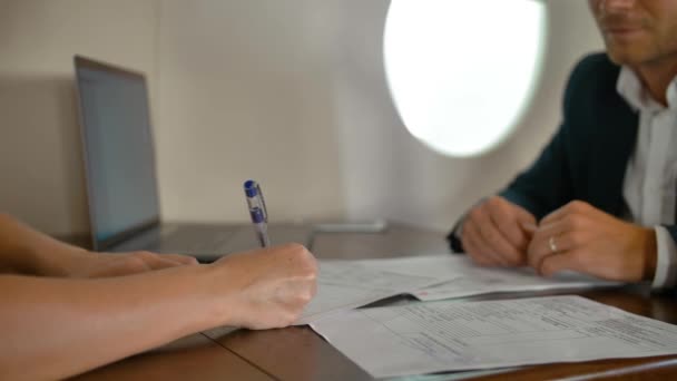 Des hommes d'affaires à l'intérieur d'un avion à réaction privé signant un contrat d'accord — Video