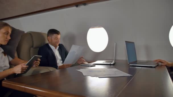 Businesspeople have private deal discussion inside of business jet — Stock Video
