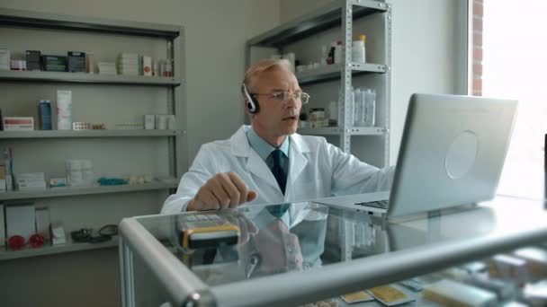 Volwassen man in headset van support consulting klanten over vaccin online — Stockvideo