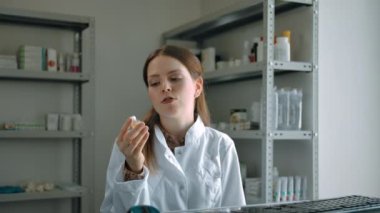 Kadın eczacı Coronavirus aşısının reklamını yapıyor ve müşterilerine veriyor.