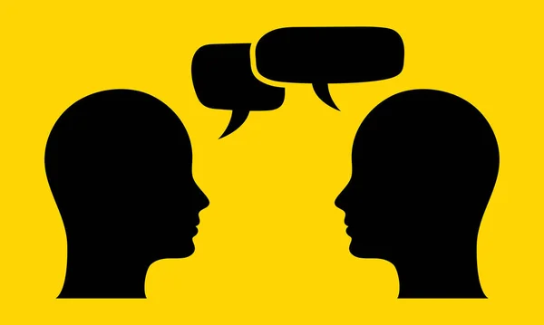 Silhouette of two human heads facing each other with speech bubbles on yellow background. Concept of communication, dialogue, discussion, conversation, social interaction, teamwork, language exchange