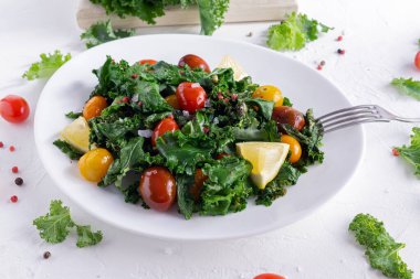 Roasted cabbage with kale and cherry tomatoes and lemon slices.