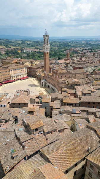 Siena from above  a medieval jewel of Tuscany, with terracotta rooftops, winding streets, and the iconic Piazza del Campo at its heart.