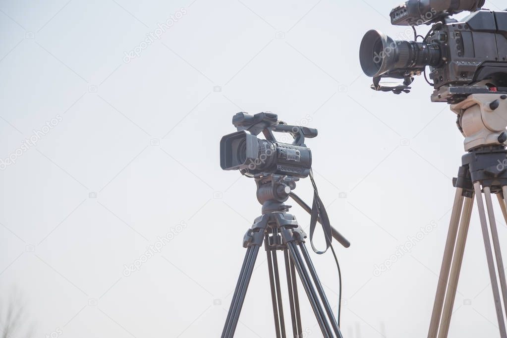 Modern digital video cameras ready to take videos on the white background.