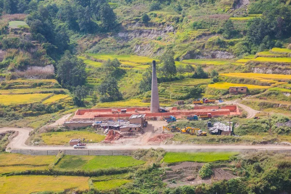 Brick factory with chimney near the rice field in the beautiful Village near Kathmandu.
