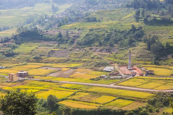 Brick factory with chimney near the rice field in the beautiful Village near Kathmandu.