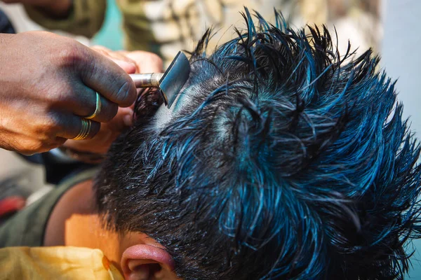 Young Man getting haircut by a barber,Hair Styles.Selective Focus