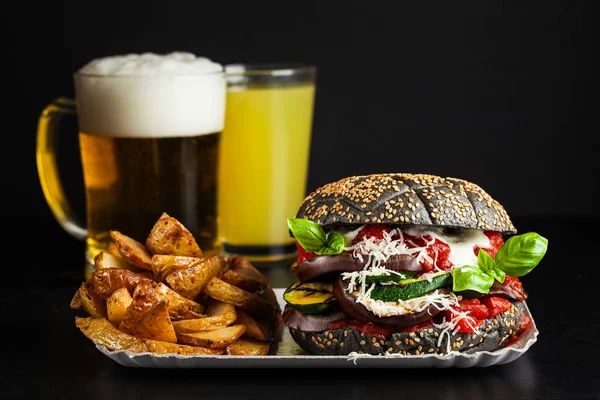 Black burger Menu with beer and with Italian stuffing of Parmigiana from eggplants, zucchini and tomato sauce. fresh basil and a lot of cheese. Ideal Italian option for a snack, lunch or light dinner. Vegan and Vegetarian Healthy Eating