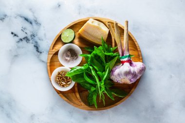 İtalyan Klasik yeşil pesto fesleğen sos yemek için taze malzemeler. çam fıstığı, sarımsak ve parmesan peyniri. beyaz mermer masaya