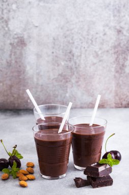Kara Orman smoothies gri yüzeyi tablo. çikolatalı milkshake ile fındık ve kiraz