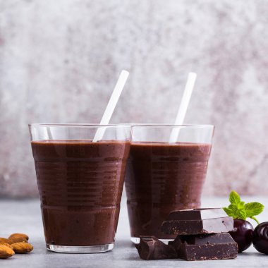 Kara Orman smoothies gri yüzeyi tablo. çikolatalı milkshake ile fındık ve kiraz