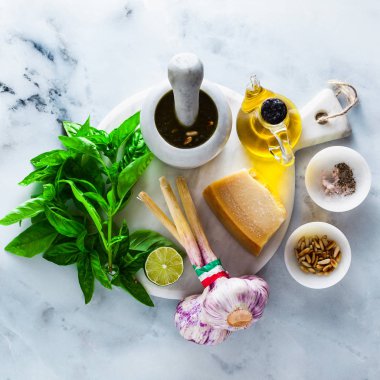 İtalyan Klasik yeşil pesto fesleğen sos yemek için taze malzemeler. çam fıstığı, sarımsak ve parmesan peyniri. beyaz mermer masaya