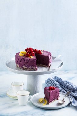 Kaju fıstığı ve yaban mersini çiğ vegan kek. sağlıklı tatlılar. süt, un ve ücretsiz gluten. ve iki mermer bir masada kahve espresso fincan