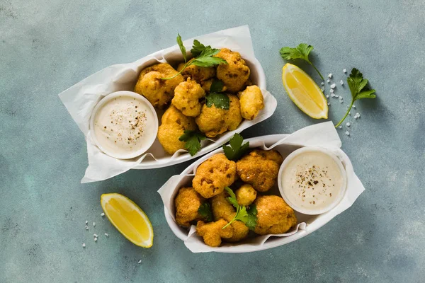 Fried cauliflower in batter with a savory sauce of cashew nuts. — Stock Photo, Image