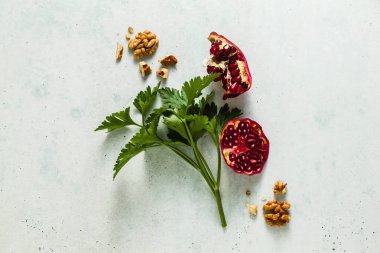 maydanoz, nar taneleri ve ceviz masanın üzerine dağılmış. sağlıklı süper gıda kompozisyonu