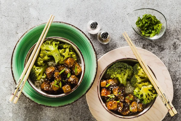 General Tso sos ve haşlanmış brokoli tofu ile basmati pirinç. tam sağlıklı vejetaryen öğle veya akşam yemeği taş bir tablo