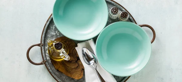 banner of empty plates on the table set for lunch or dinner.