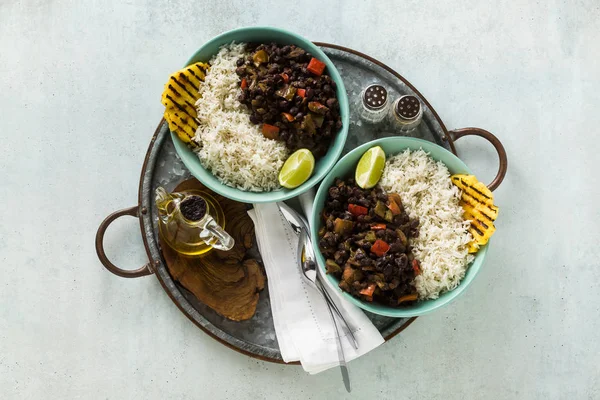 Cuban rice and black bean dish with grilled pineapple. Healthy Vegan Caribbean food for the whole family, party or restaurant menu