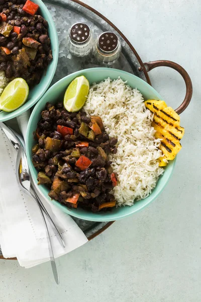 Cuban rice and black bean dish with grilled pineapple. Healthy Vegan Caribbean food for the whole family, party or restaurant menu