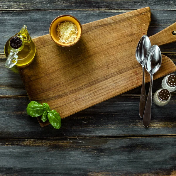 Cutting wooden board from olive wood on a blue wooden table with