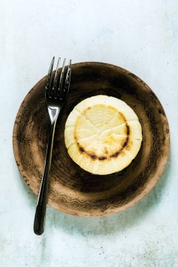 Fırında pişmiş ricotta peynirkil bir tabak ve çatal üzerinde. temel cookin