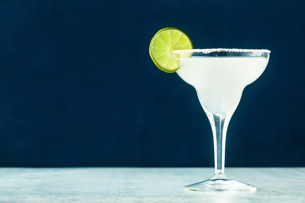 classic margarita cocktail on the table with bar accessories.