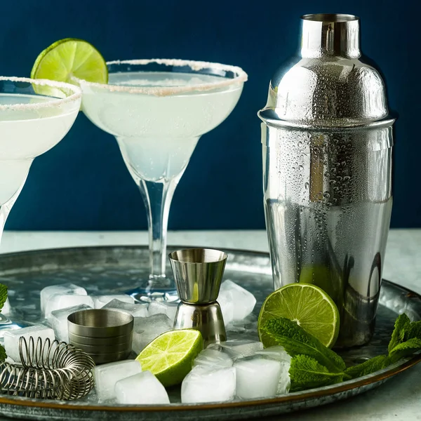 classic margarita cocktail on the table with bar accessories.