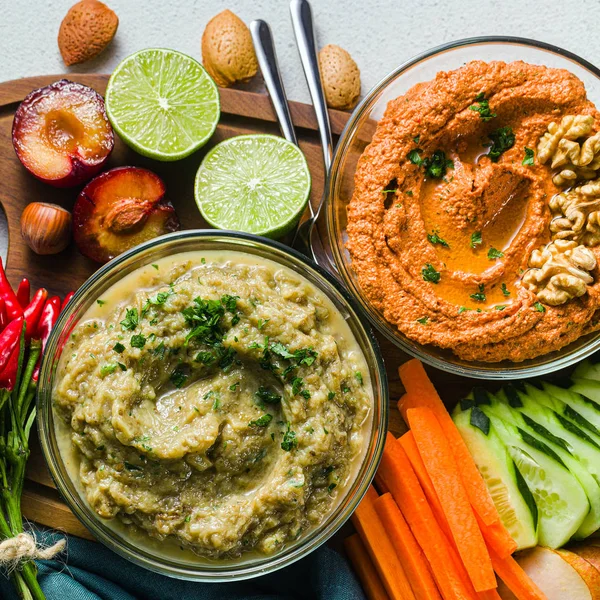 veggie serving table with snacks with vegetables, fruits, baba g