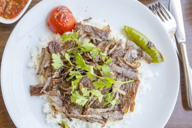rice with meat and parsley on the plate