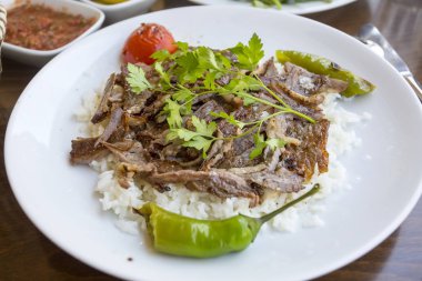 rice with meat and parsley on the plate