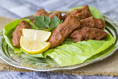 turkish dish with lemon and green salad
