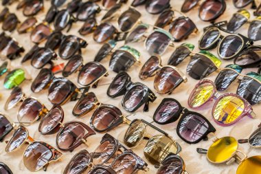 close up of a lot of different sunglasses