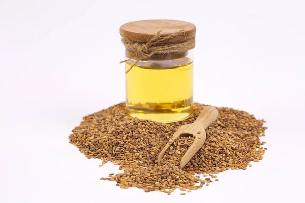 Bottle of sesame oil and sesame seeds isolated
