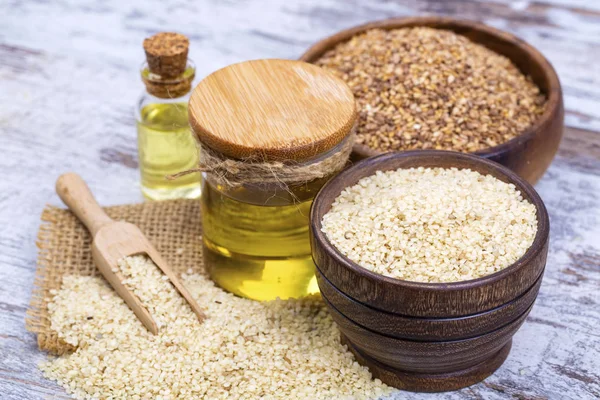 Bottle of sesame oil and sesame seeds isolated