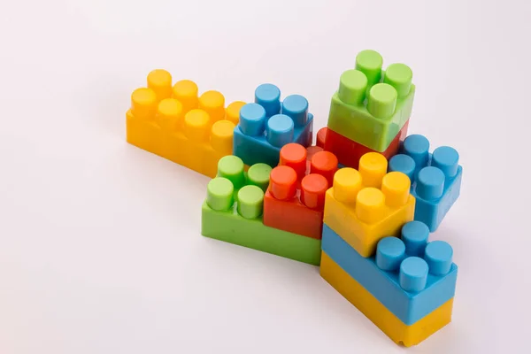 Children toys; colorful plastic blocks on the white background.