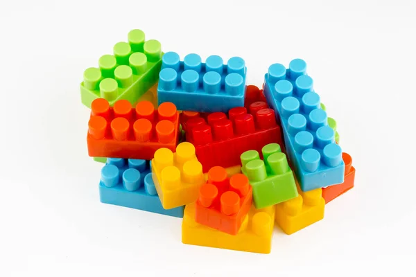 Children toys; colorful plastic blocks on the white background.