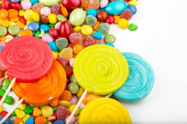 Renkli lolipoplar ve farklı renkte yuvarlak şekerler. Üst görünüm.
