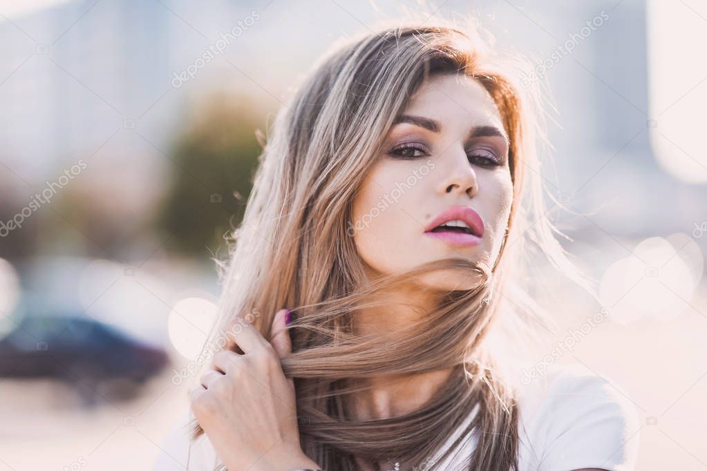 emotional portrait of Fashion stylish sexy of  young hipster blonde woman, elegant lady, bright colors dress, cool  girl. City view  urban lifestyle background.