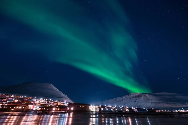 The polar arctic Northern lights aurora borealis sky star in Norway Svalbard in Longyearbyen the moon mountains